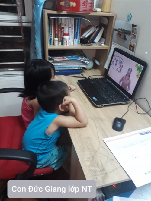 2 chị em bé Đức Giang lớp Nhà trẻ chăm chú học qua video cùng cô